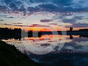 A reflection of a colorful sunset in the river Sava in Bosanski Brod