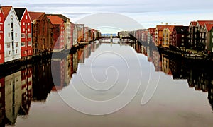 Reflection of colourful buildings on the Nidelva River in Trondelag county, Trondheim, Norway