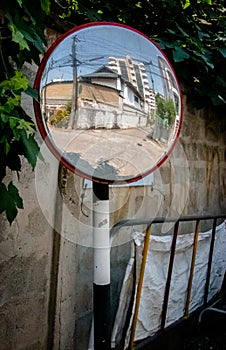 Reflection in concave lens mirror. Street or Traffic Concave Mirror.