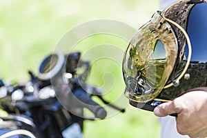 Reflection of custom made scrambler style cafe racer in the helm