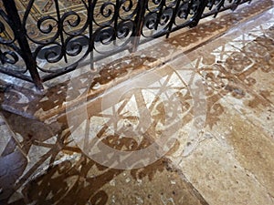 Reflection of a decorative wrought iron gate