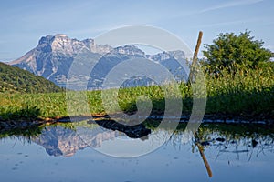 Reflection of Dent de Crolles summit in a small pond
