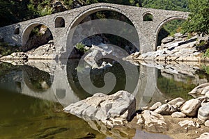 Reflection of Devil`s Bridge in Arda river and Rhodopes mountain, Bulgaria