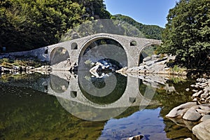 Reflection of Devil's Bridge and Rhodopes mountain in Arda river, Bulgaria