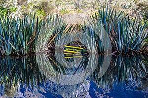 Reflection of Earl Mountains and signage of the Mirror Lakes on the Mirror Lakes