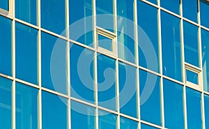 Reflection of the facade of a modern building in a glass window