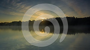 Reflection of the first rays of dawn sunlight in the lake.