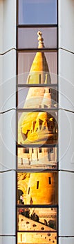 Reflection of Fisherman`s Bastion, aka Halaszbastya, fairy tale towers in modern hotel windows. Architectural contrast