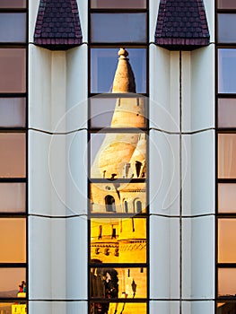 Reflection of Fisherman`s Bastion, aka Halaszbastya, fairy tale towers in modern hotel windows. Architectural contrast