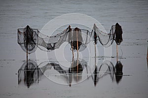 Reflection of fishnets on Limfjord, Denmark