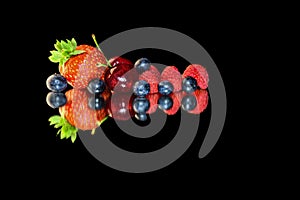 Reflection of fruits, in a mirror on a black background photo
