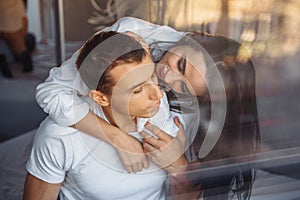 Reflection in glass, in a mirror. Hot couple in love man and woman slowly undress each other before sex. Love making, relaxing in