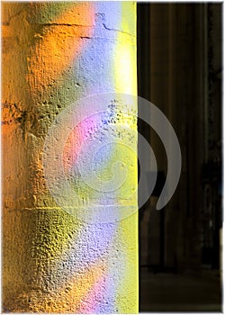 The reflection of the glass stained windows on the column in Lyon Cathedral, France