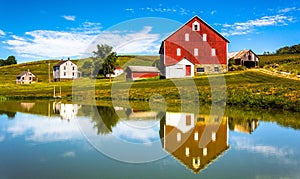 Reflection of house and barn in a small pond, in rural York County, Pennsylvania.