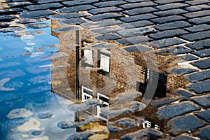 Reflection of House in Puddle