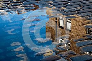 Reflection of House in Puddle