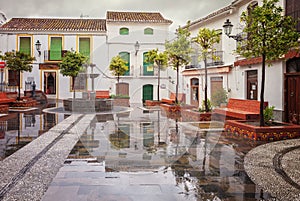 Reflection of houses in the town hall square of Salobrena village, Granada province, Andalusia, Spain