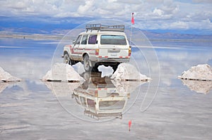 Reflection of jeep in flooded Salar de Uyuni