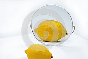 Reflection of lemon with thick peel in mirror - Metaphor of cosmetic procedure for cleansing pores