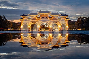 Reflection of the Liberty Square Arch on the rainwater in the evening in Taipei, Taiwan
