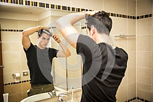 Reflection of Man Bushing Hair in Mirror