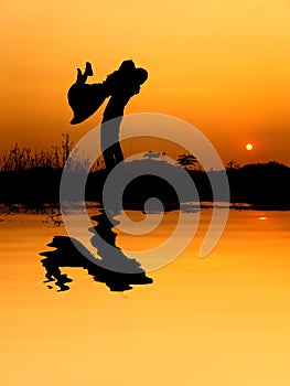 Reflection of Man and Woman love silhouette in sunset