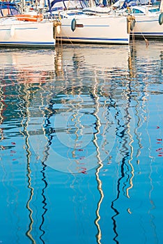 Reflection of the masts of yachts in water