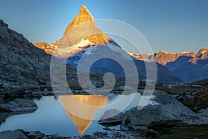 Reflection of the Matterhorn on blue lake at sunrise, Swiss Alps, Zermatt