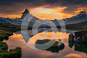 Reflection of matterhorn in mountain lake at sunset