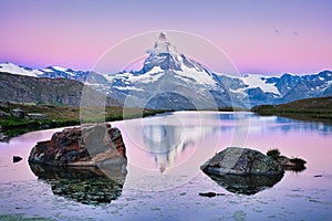 Reflection of Matterhorn mountain in Stellisee lake at sunrise