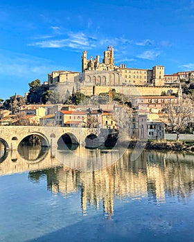 reflection of the medieval bridge over the river