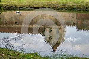 Reflection of Medieval Fagaras fortress in the castle moat. Fagaras, Brasov County, Transylvania, Romania