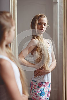 Reflection in mirror of teenage girl