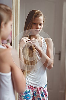 Reflection in mirror of teenage girl photo