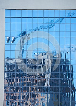 Reflection of the modern apartment building under construction