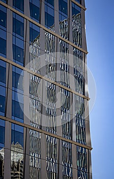 Reflection of a modern office building into the glass of another modern office building