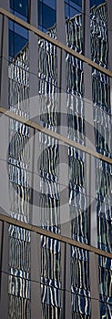 Reflection of a modern office building into the glass of another modern office building
