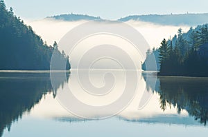 Reflection of Morning Fog Rising on Lake