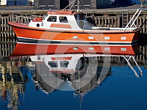 Reflection of a motorboat in the water