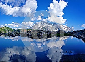 Reflection of Mountains and Clouds in Alpine Lake