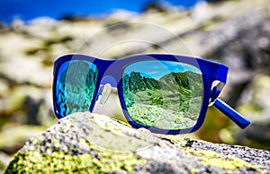 Reflection of mountains in sunglasses