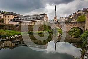 Reflection of NeumÃ¼nster Abbey at the bank of Alzette River in Luxembourg CityLuxembourg
