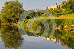 The reflection of Novigrad na Dobri fortress on the Dobra River