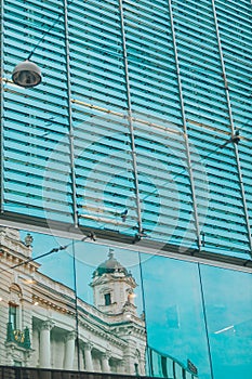 reflection of old building in glass window