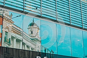 reflection of old building in glass window