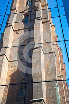 Reflection of an old, gothic church in the glass