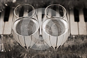 Reflection of piano keys in two wine glasses, pianoforte