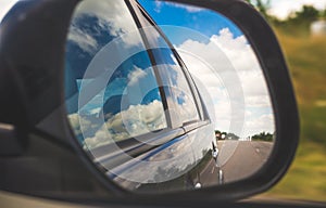 Reflection in the rear view mirror. Road trip