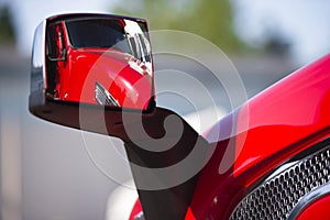 Reflection of the red semi truck in the modern style mirror