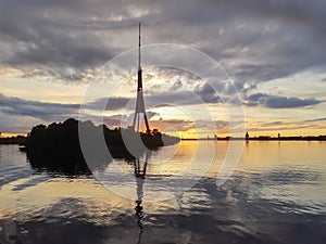 Reflection of Riga TV tower in the waves of Daugava river
